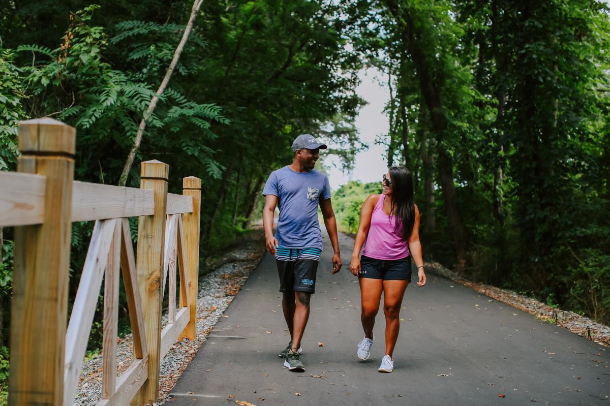 Visitors wander along a paved tree-lined trail in  Rutherford County.