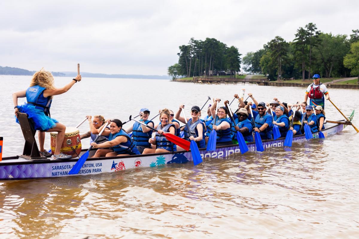 Group in a dragon boat at the 2024 Rowan County Chamber of Commerce Dragon Boat Festival