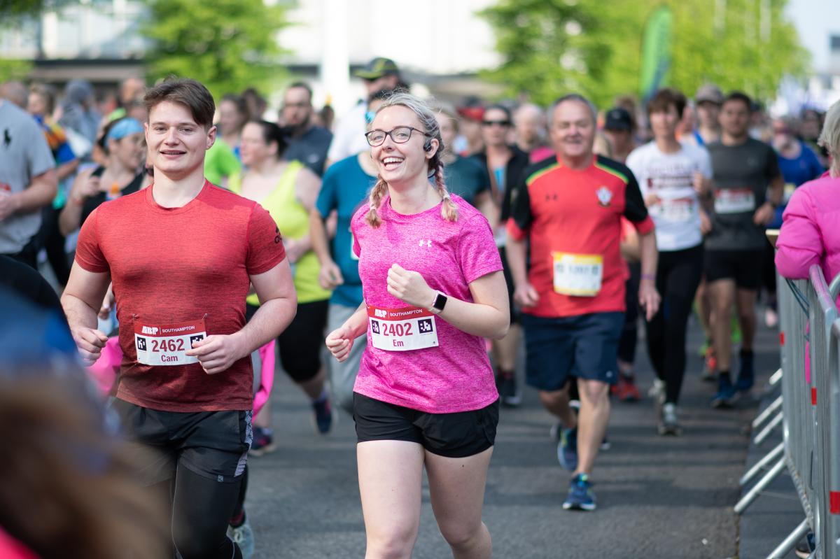 ABP Marathon runners smiling as they run past camera