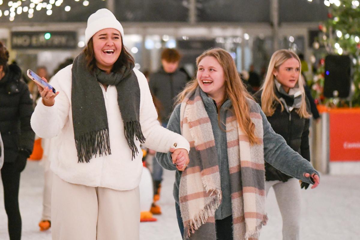 Two girls holding hands whilst skating at Westquay On Ice