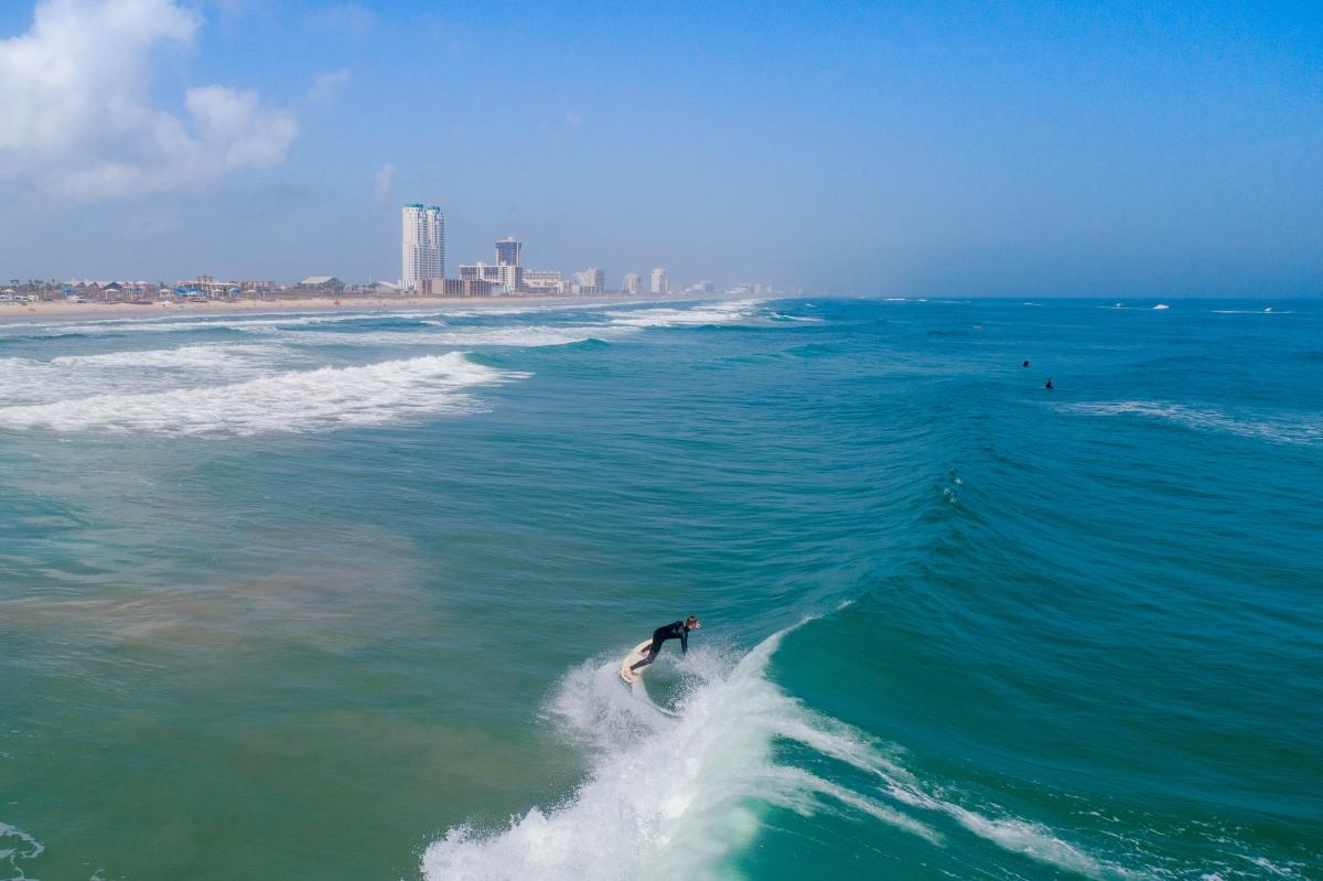 Man surfing off the coast