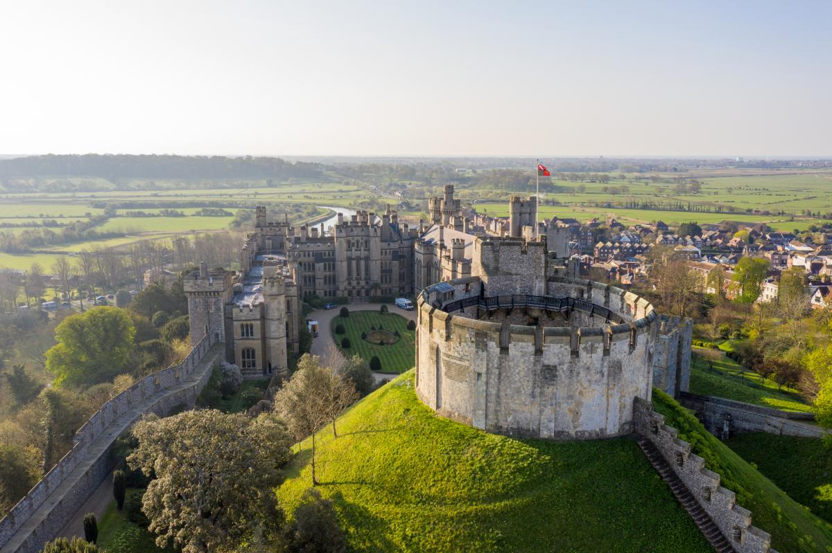 Aerial view of the keep at Arundel Castle with Arundel and fields in the distance