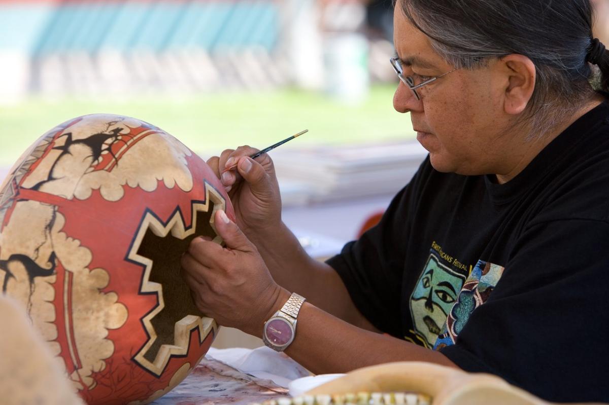 An artist paints traditional pottery in New Mexico.