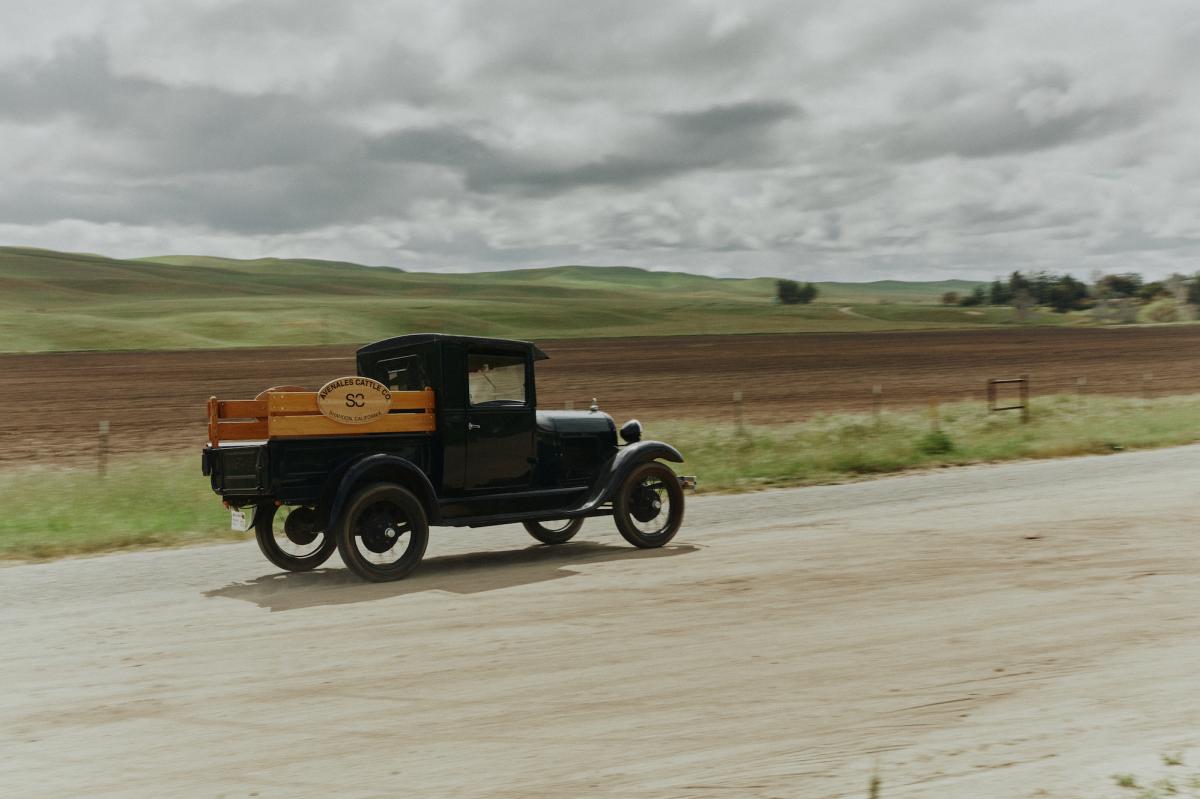 The classic truck on Avenales Ranch driving down the road.