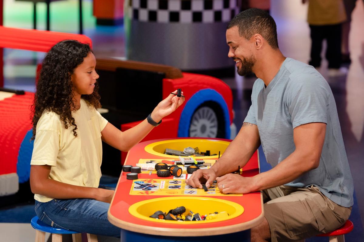 Parent and child play with the blocks at LEGOLAND Discovery Center in Plymouth Meeting