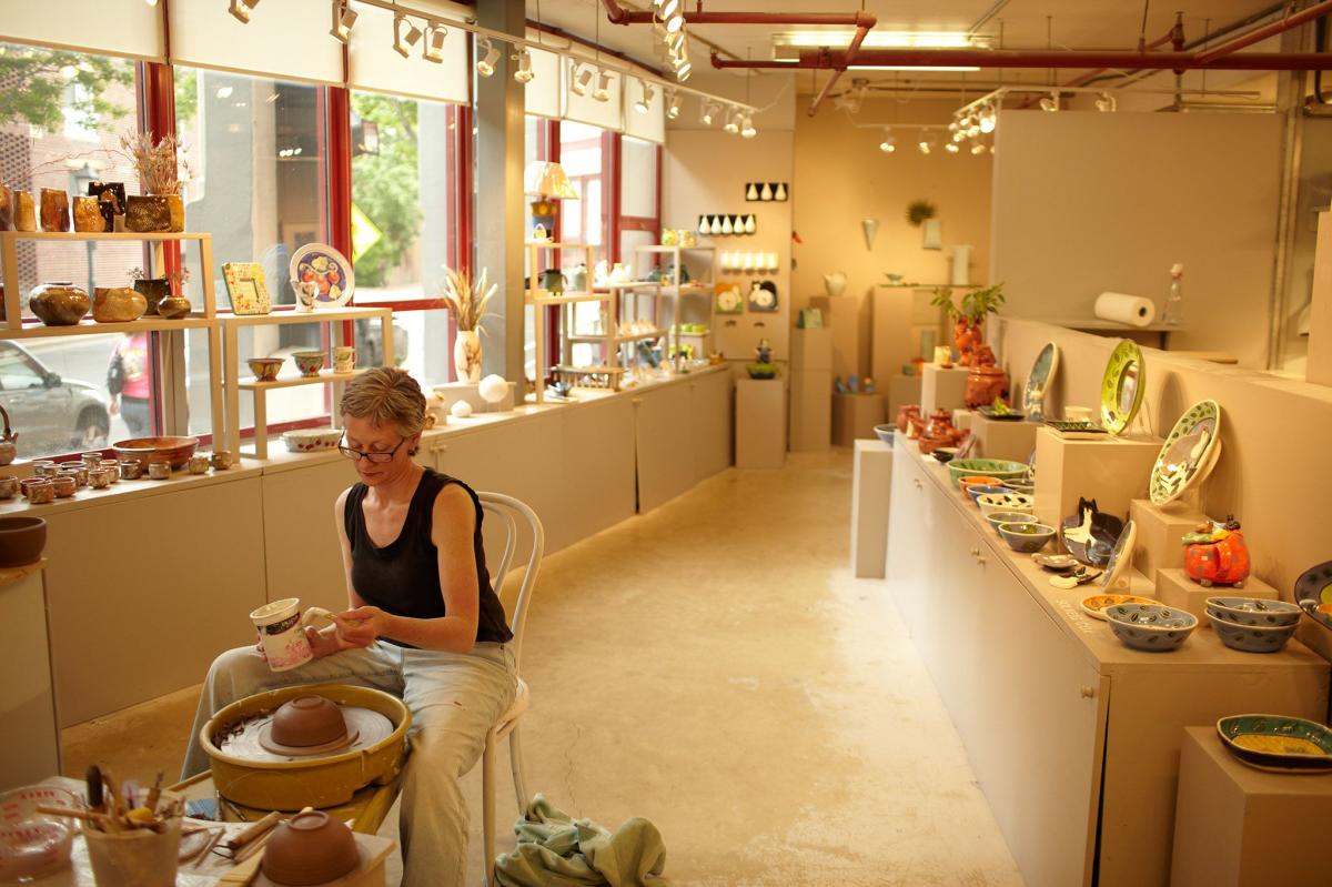 Artist sculping on a pottery wheel in her studio at the Torpedo Factory in Alexandria, Virginia