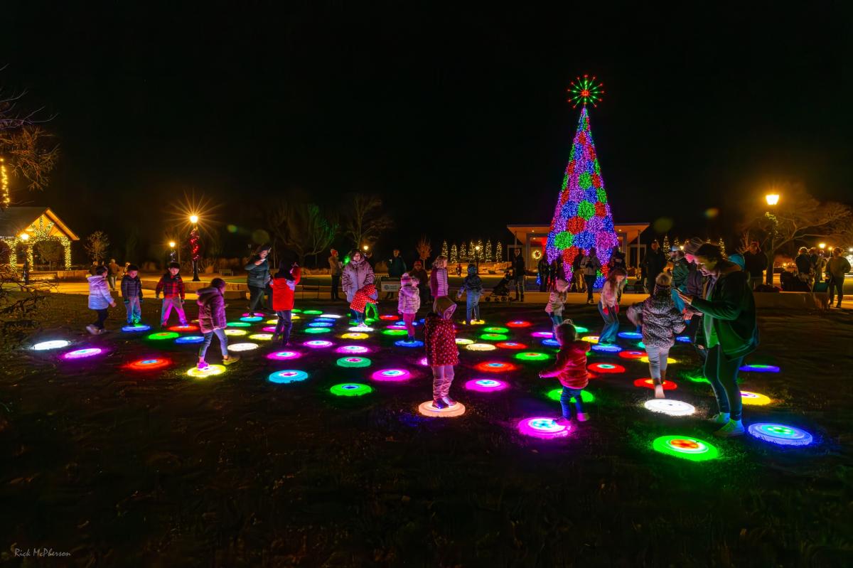 Lights illuminate spots on the ground at Illuminations at Botanica Wichita