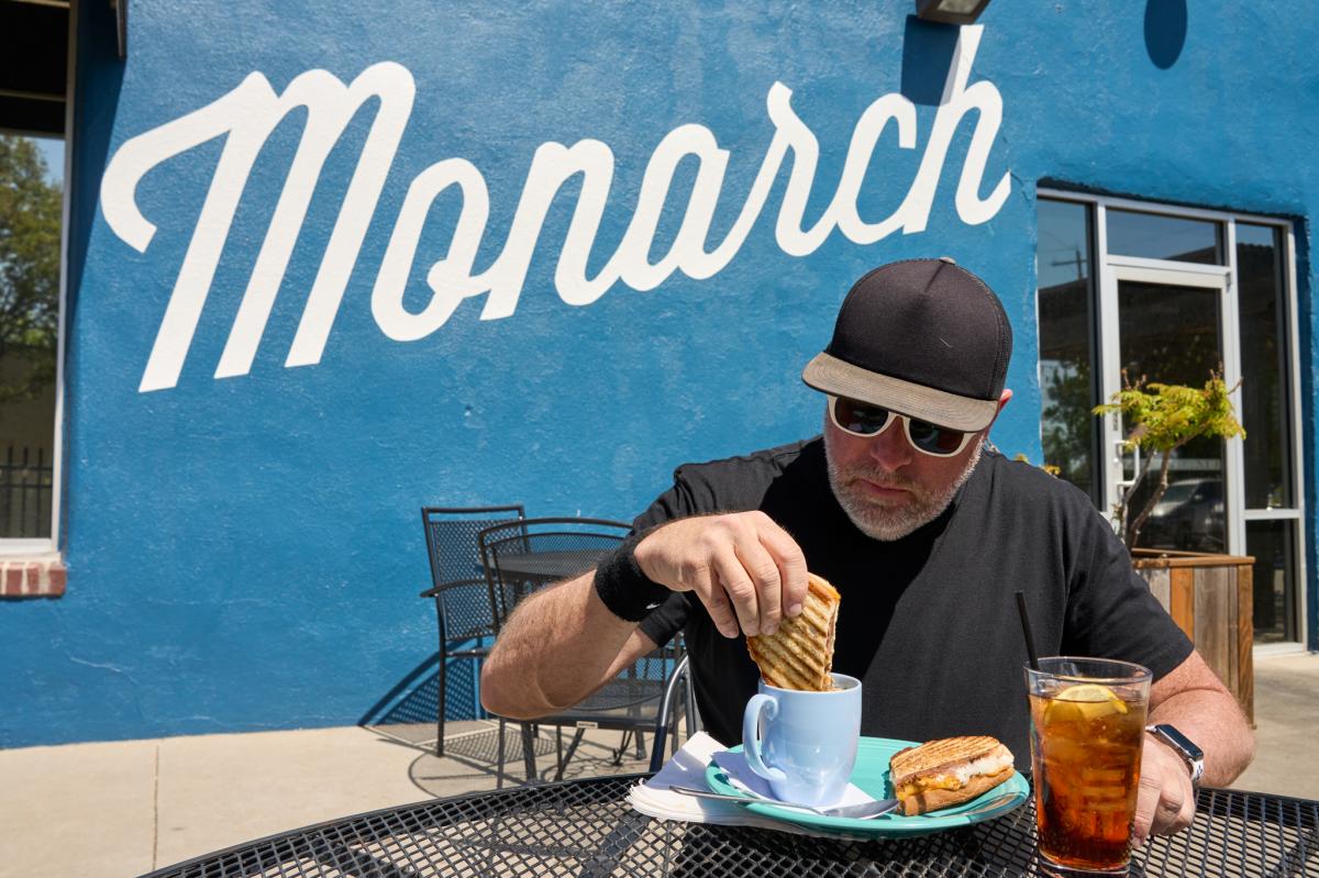 Darrin Hackney dips a sandwich into a mug of soup at Monarch