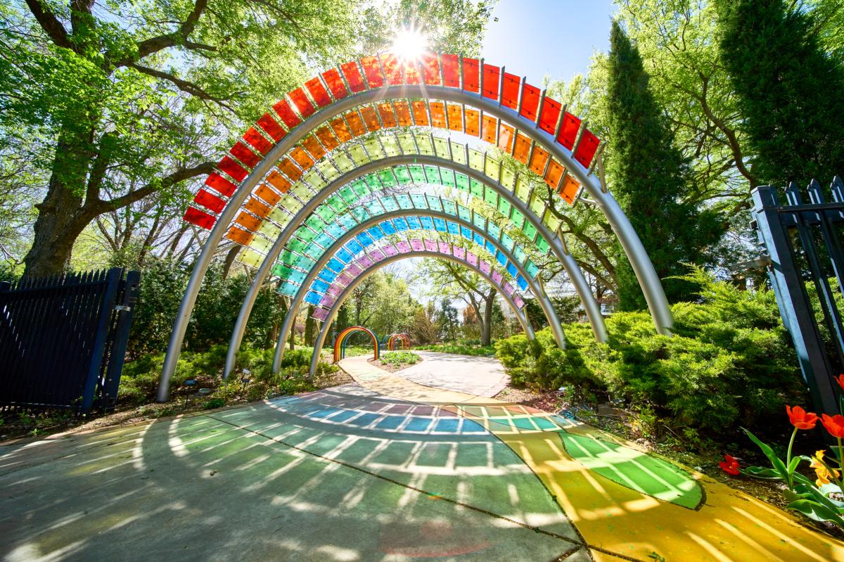 A photo of the rainbow structure is taken in the Children's Garden at Botanica by Darrin Hackney