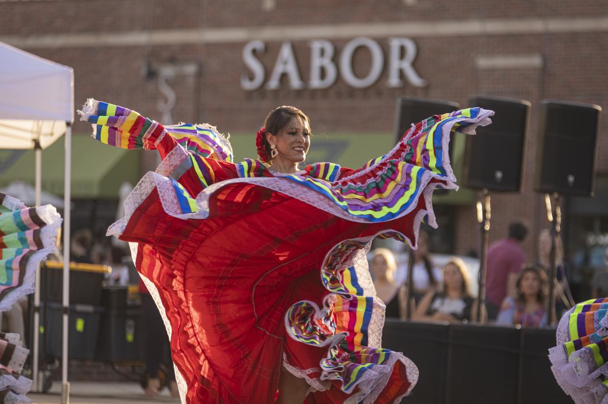 A woman dances in Old Town Square during Latin Fest ICT