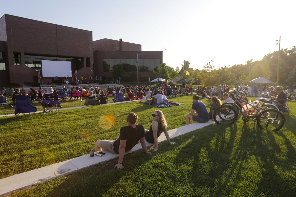 Movie goers sprawl out on the lawn outside of Wichita Art Museum for the event Tune + Tallgrass