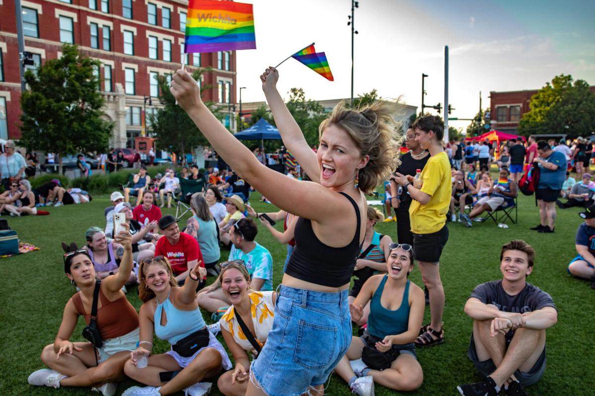 A woman cheers during the Wichita Pride Festival at Naftzger park.