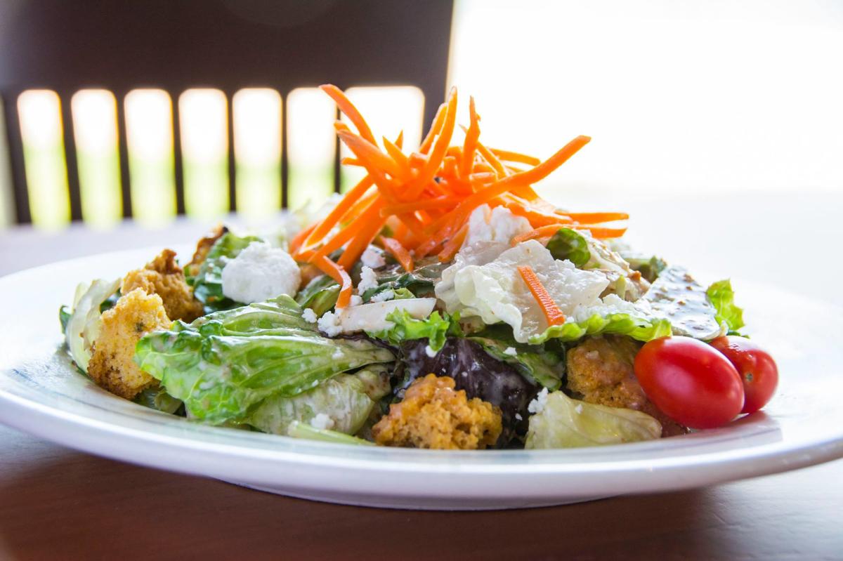 Fresh green lettuce is topped with cheese, carrots and cherry tomatoes to make the house salad at Redrock Canyon Grill