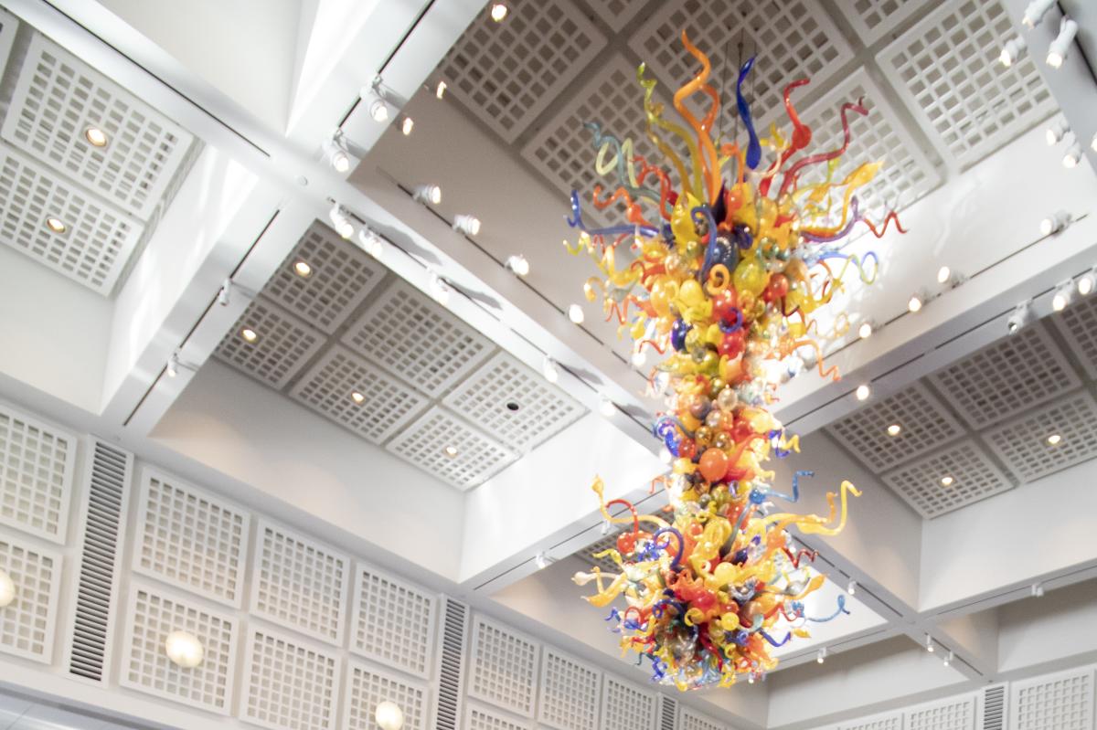 A Chihuly glass sculpture hangs from the ceiling at Wichita Art Museum