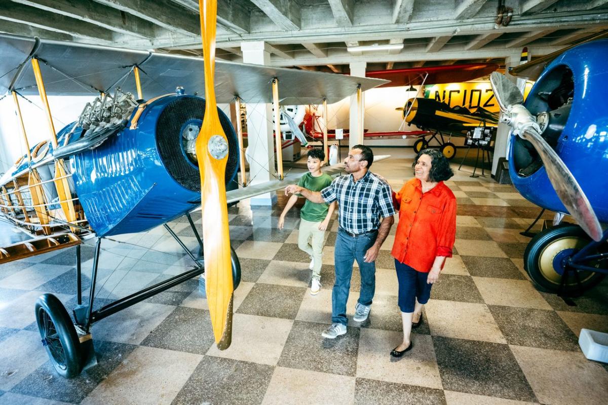 A mother, father and son explore a plane at the Kansas Aviation Museum