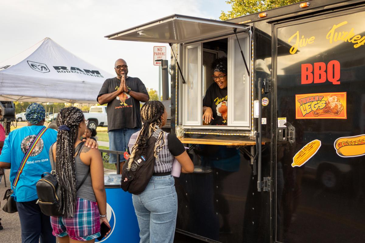 Customers line up to order food at a food truck during the Final Friday Food Truck Rally in Wichita