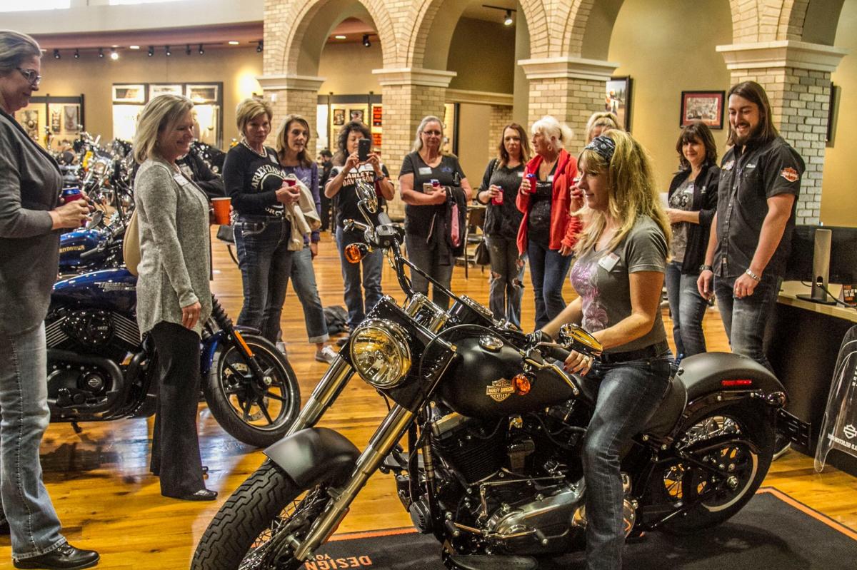 A woman sits on a motorcycle at Twister City Harlye-Davidson