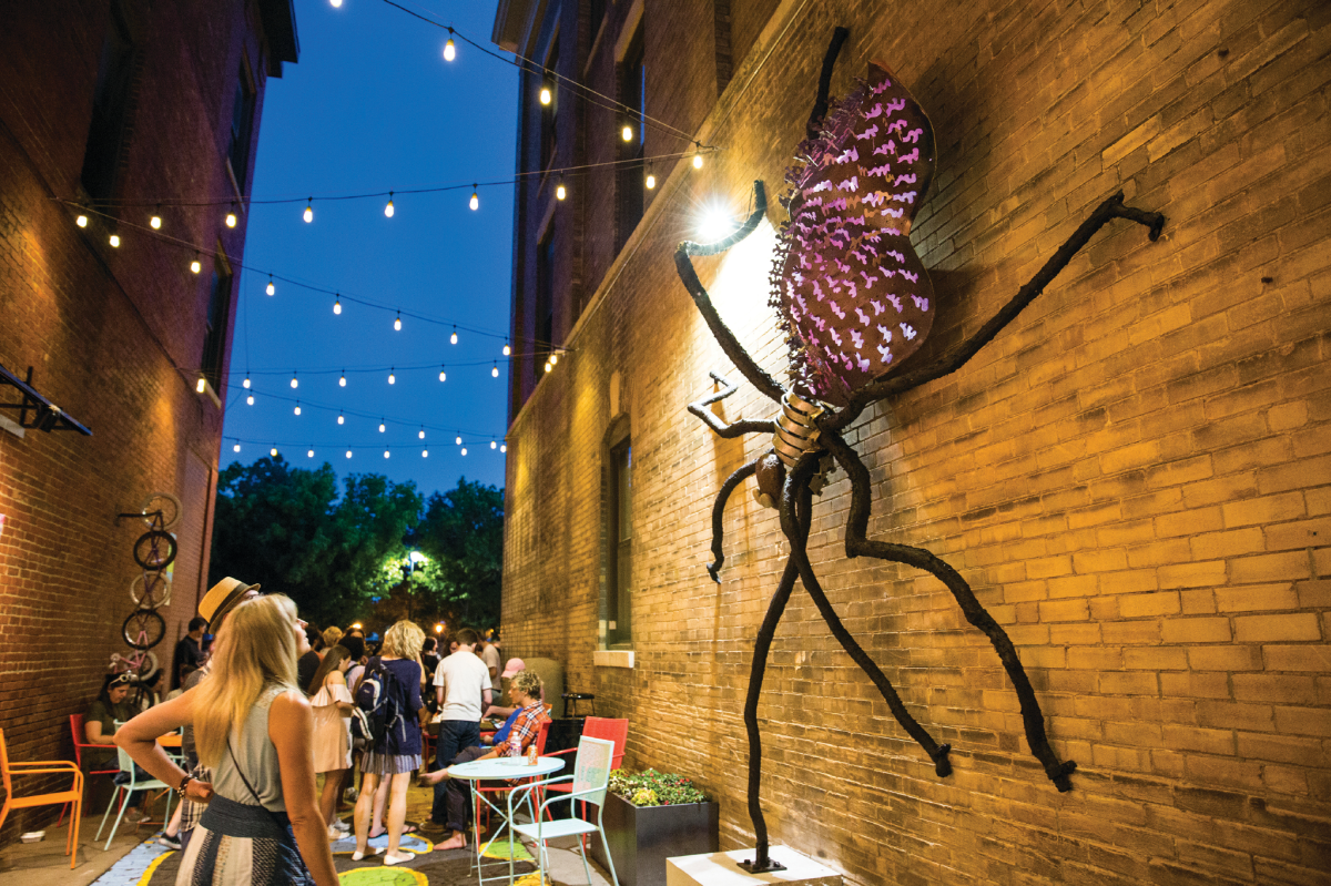 People In Gallery Alley looking at an art installation on the wall