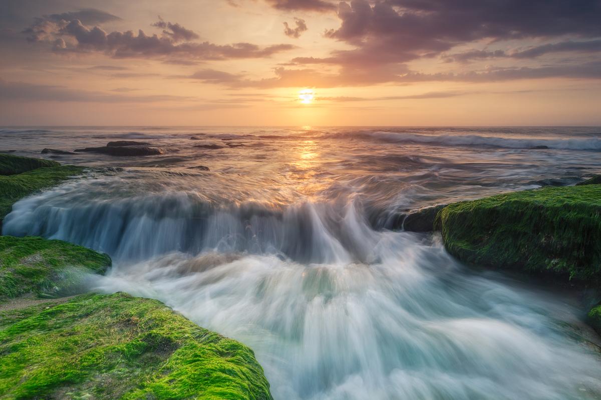 Water Flowing Over Coquina Rocks at Sunset