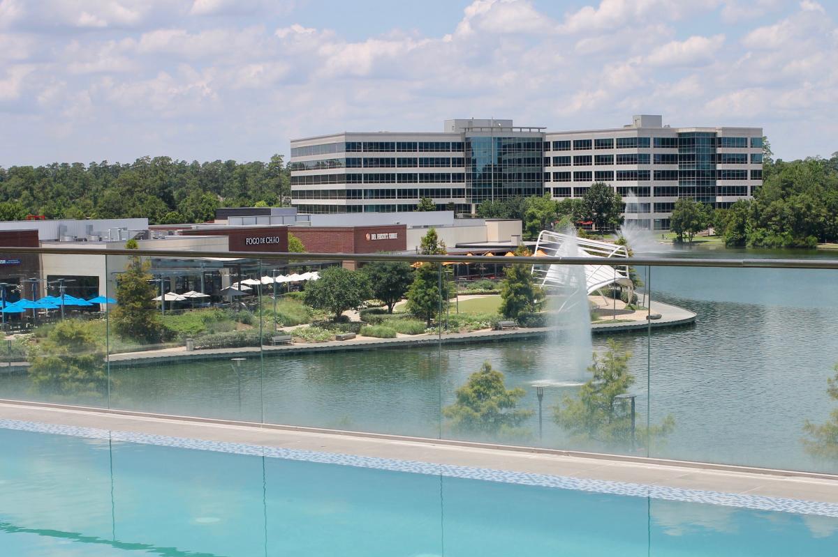 View from infinity pool at Embassy Suites overlooking Restaurant Row and Lake Woodlands at Hughes Landing