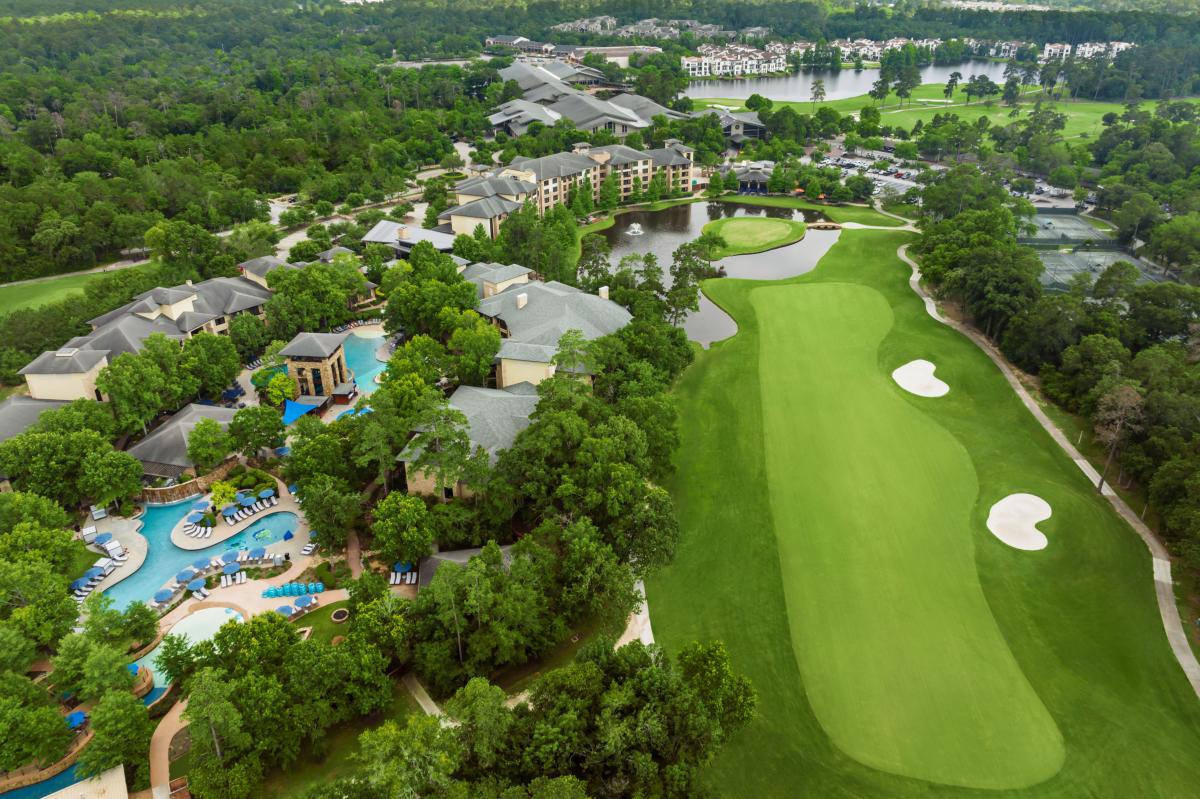 An aerial photo of The Woodlands Resort hotel, pool, lazy river, and various golf courses.