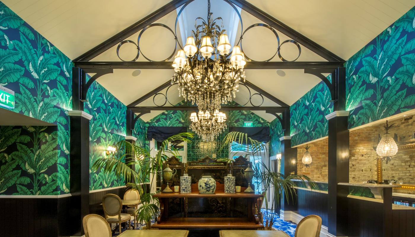 Hulbert House lounge with palm tree decor