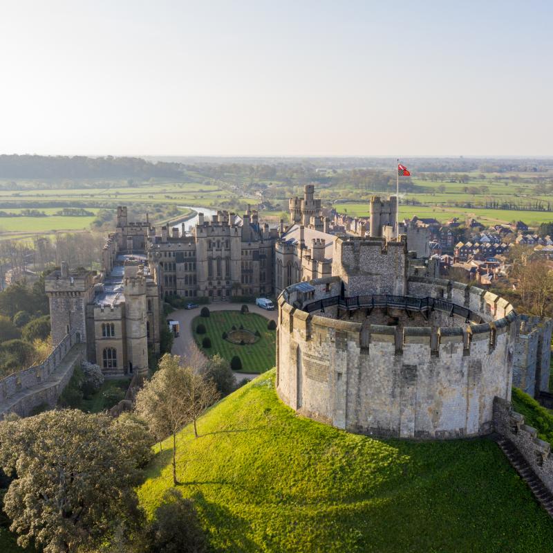 Aerial view of the keep at Arundel Castle with Arundel and fields in the distance