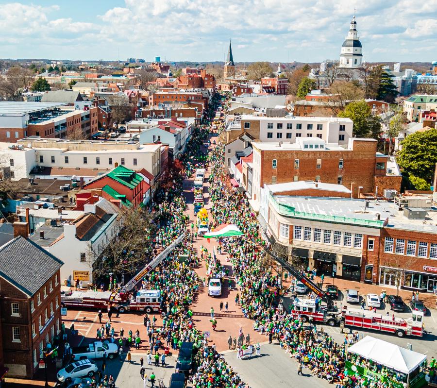 Parade crowd of green and orange on historic streets of Annapolis