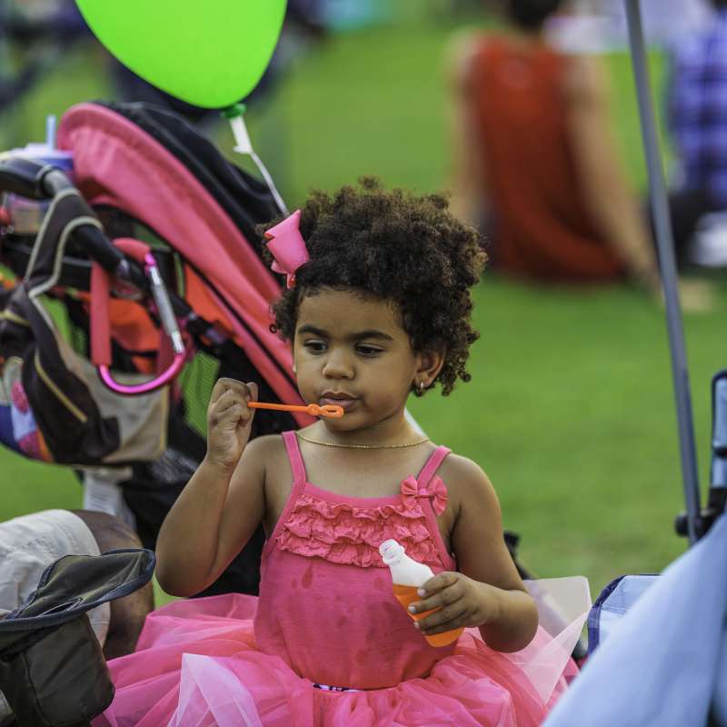 Young child blowing bubbles at Fayetteville NC event