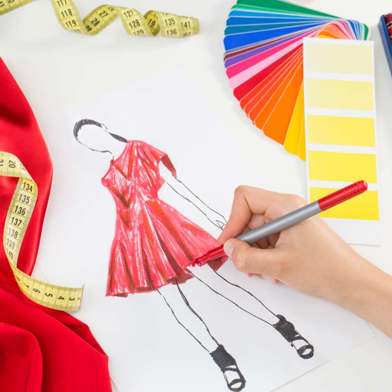 Person drawing a design for a new dress