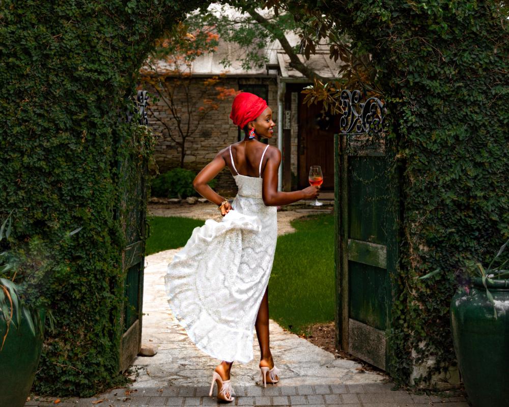 Laolu Onabanjo walks through gate at a winery in Driftwood Texas near Austin.