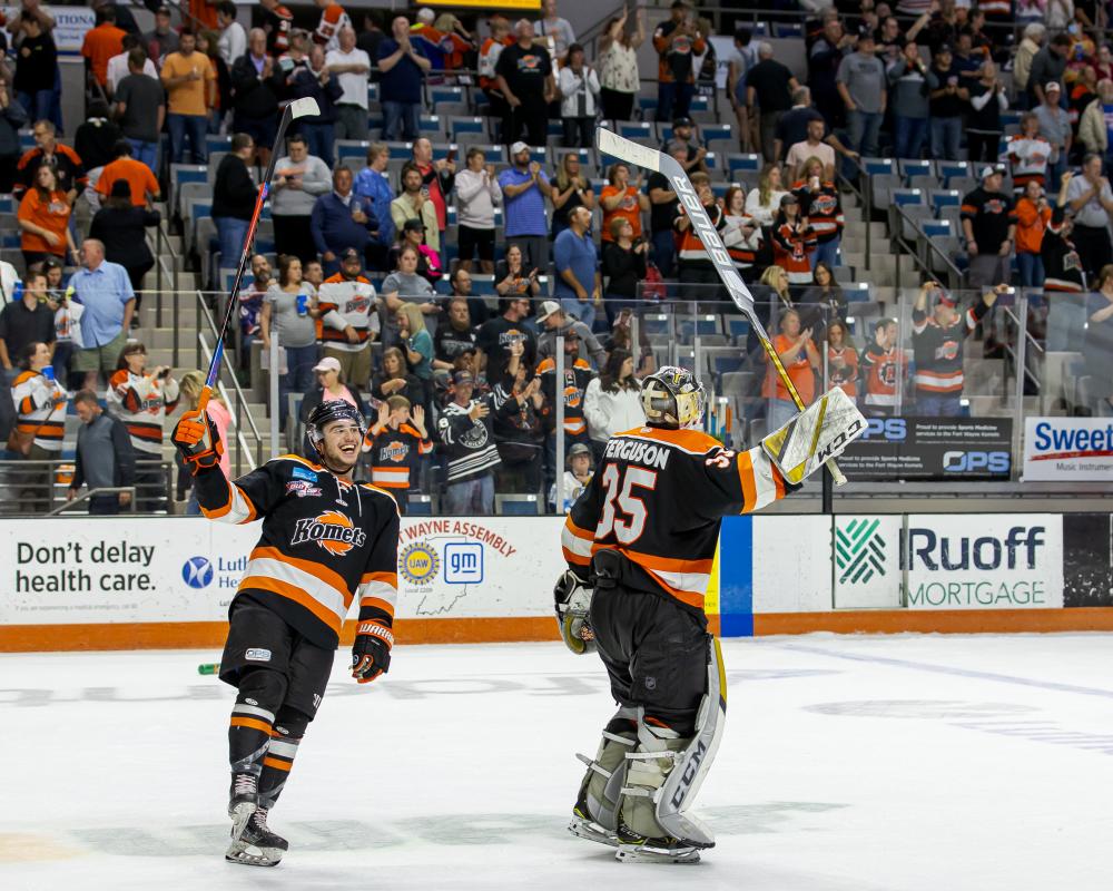 komets hockey players celebrate a goal