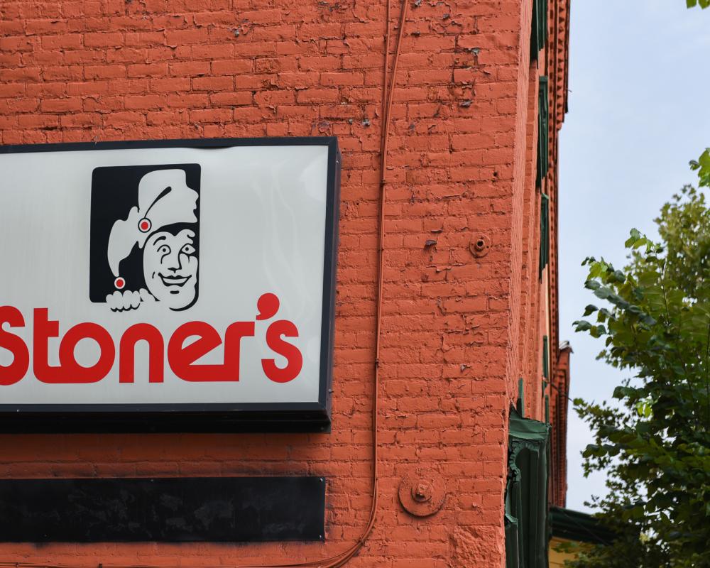 On a red brick wall and sing reads "Stoner's"