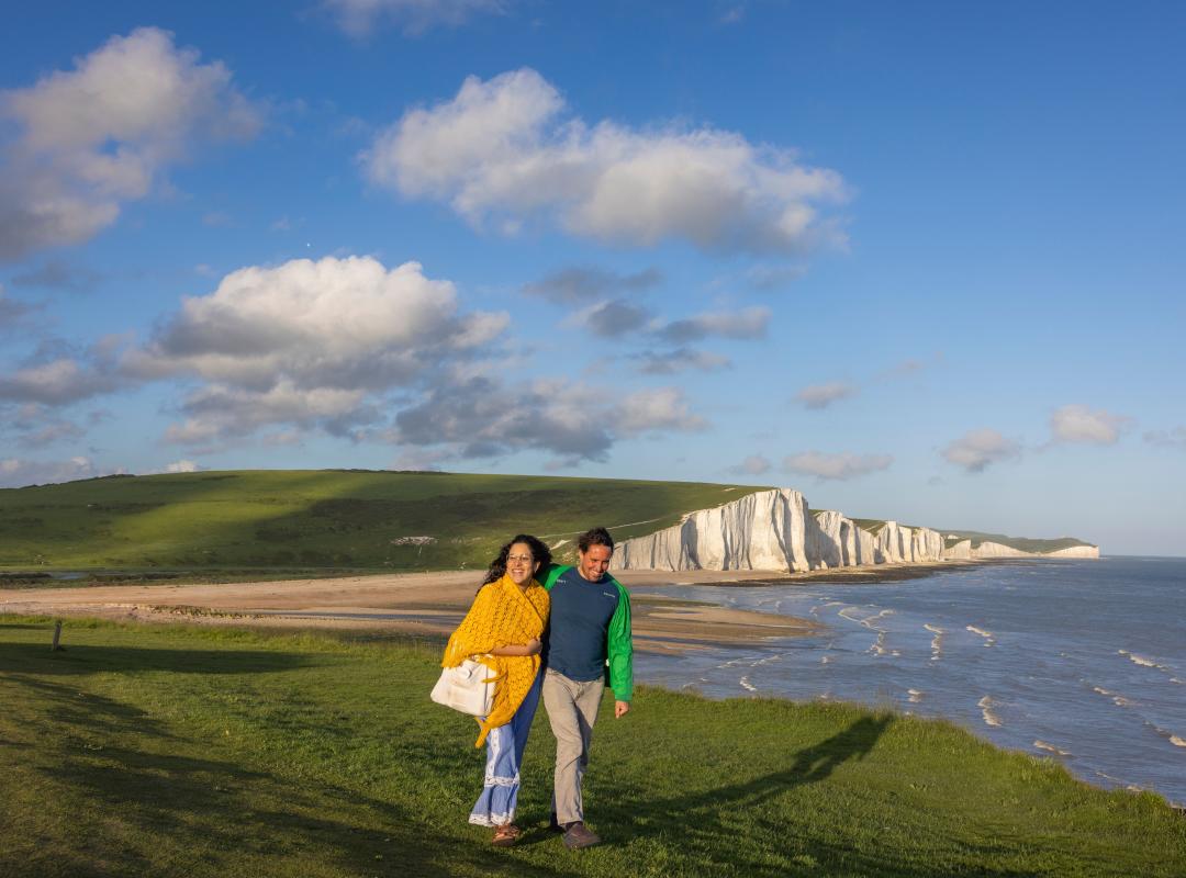 A man and woman walk along the cliffs at Seven Sisters, Sussex