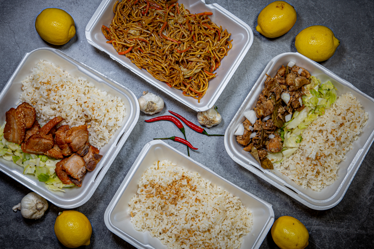 A photo of four takeout containers filled with food from Barkadas.