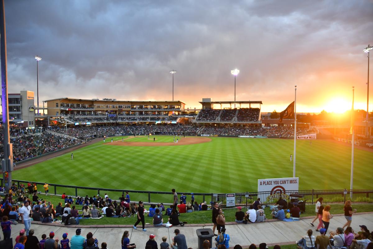 Isotopes Park from the berm area with the sun setting in the background.