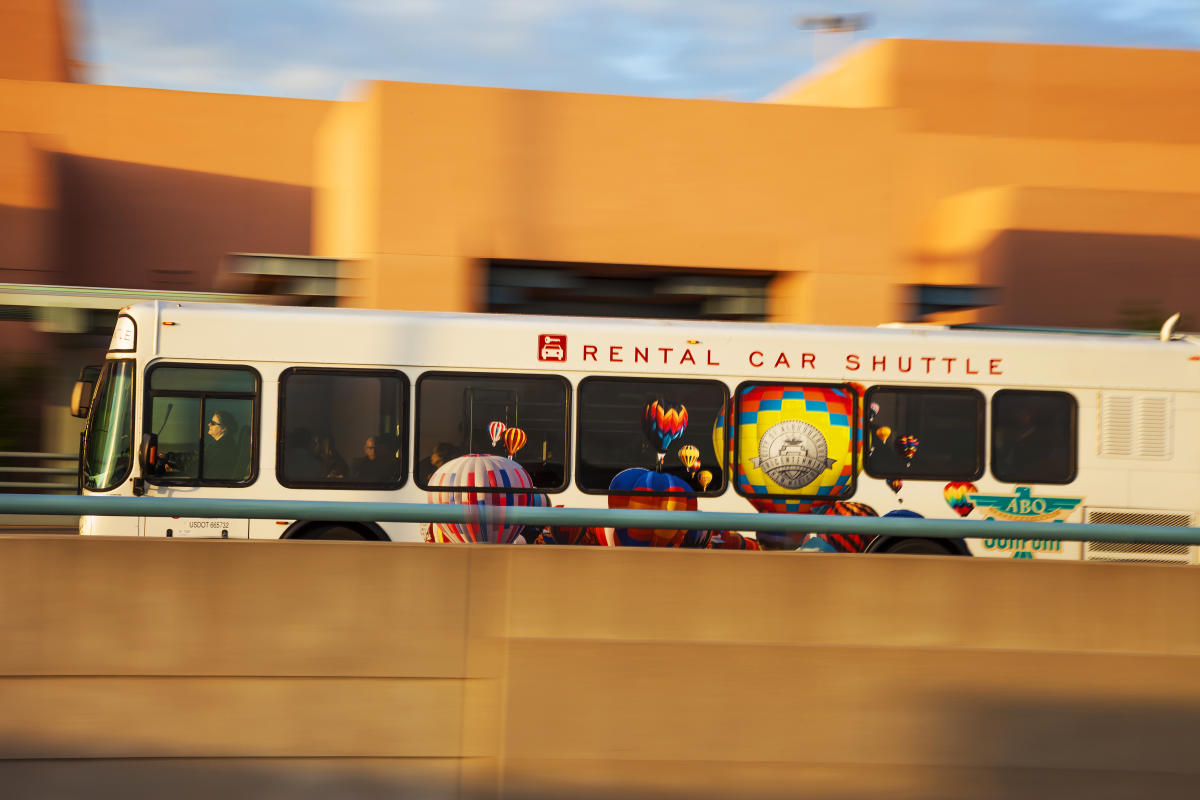 A rental car shuttle drives past the pick-up point at the Albuquerque International Sunport.