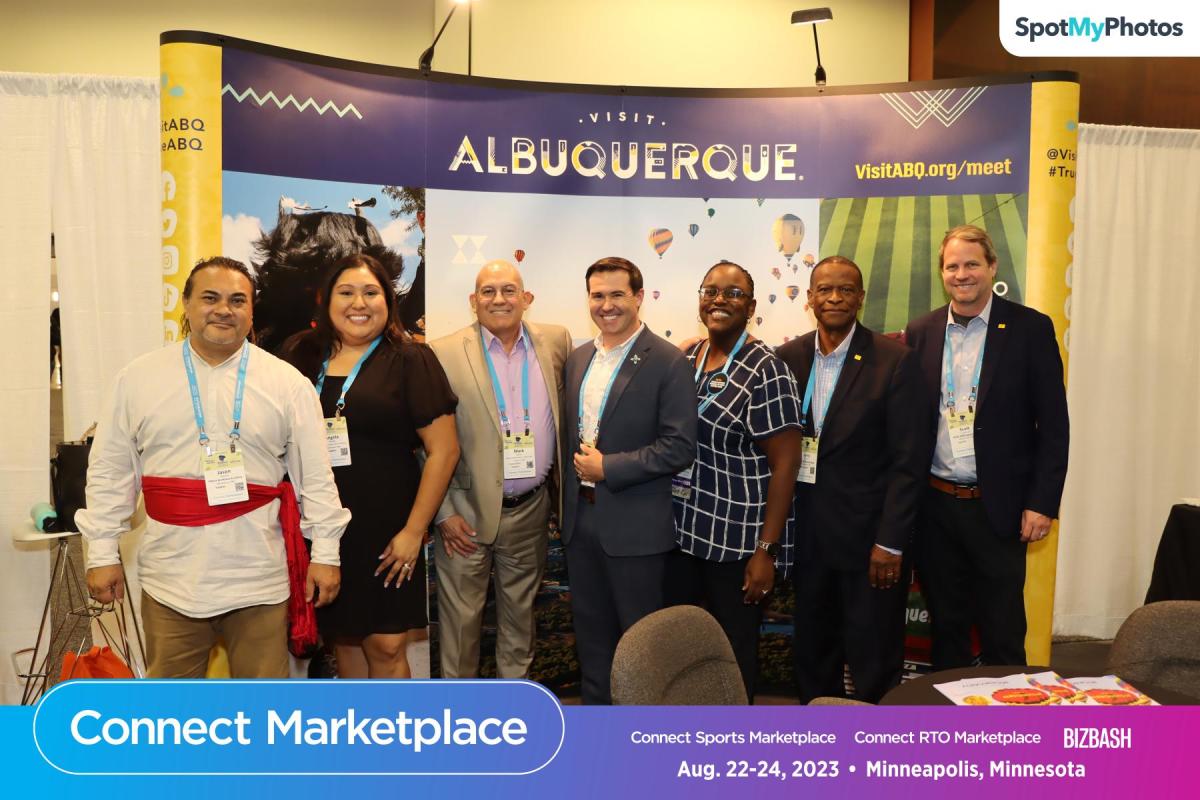 The Visit Albuquerque team stands in front of the Visit Albuquerque booth at Connect Marketplace