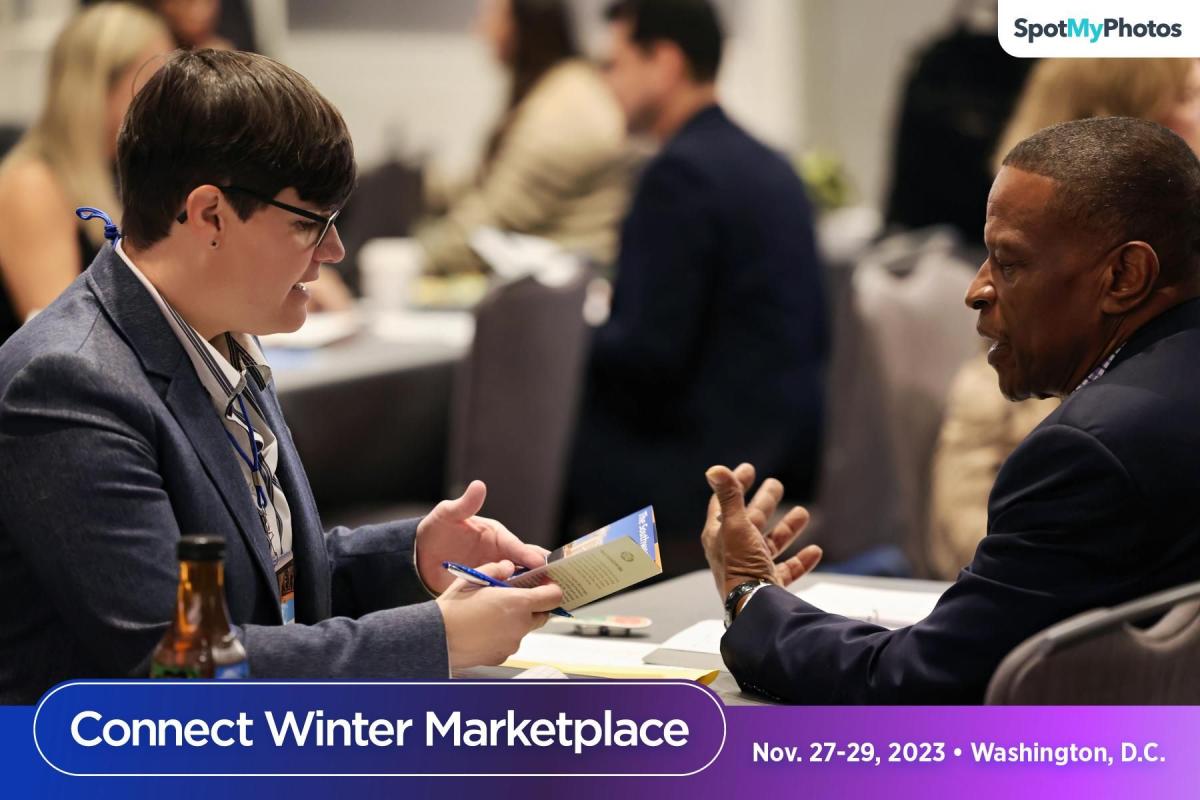 Larry Atchison talks with someone at Connect Winter Marketplace in Washington DC