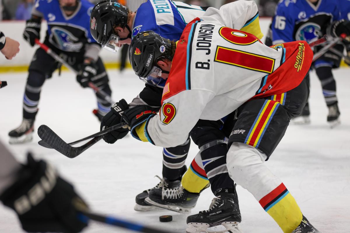 New Mexico Ice Wolves players play a game of hockey against an opposing team.