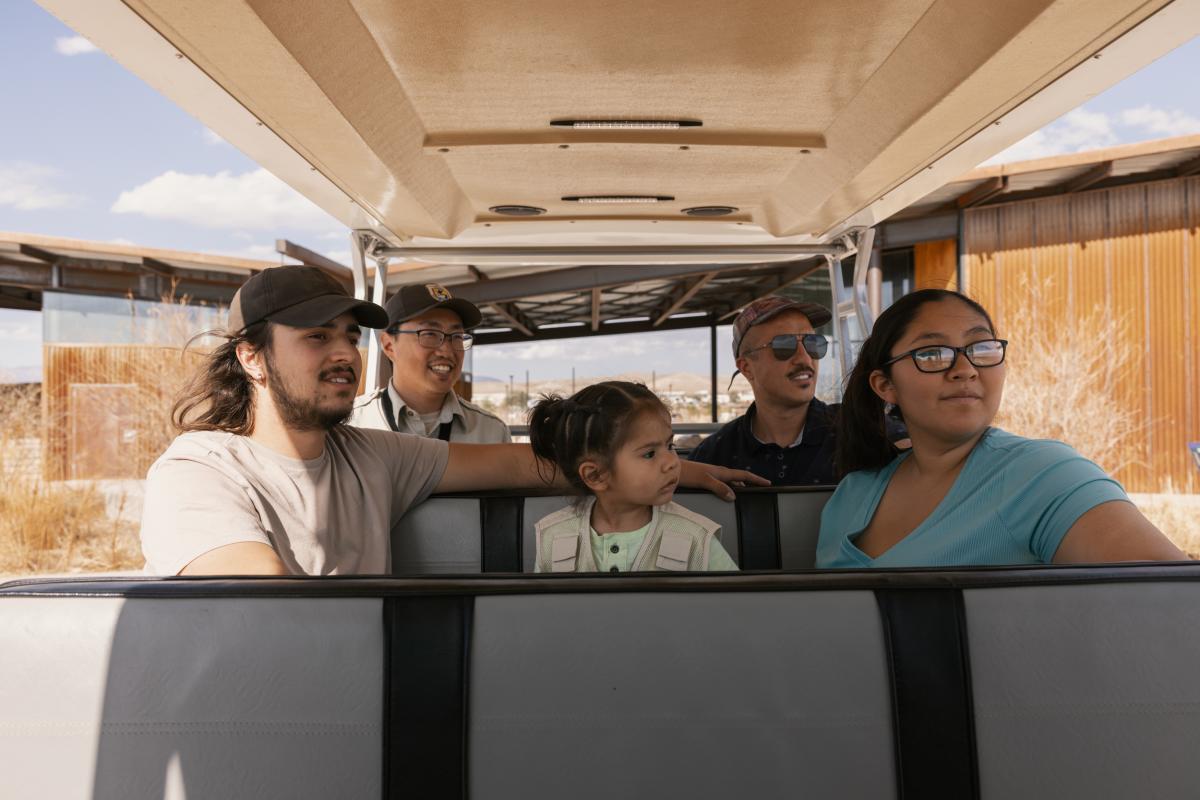 A family rides in an open air van at Valle de Oro.