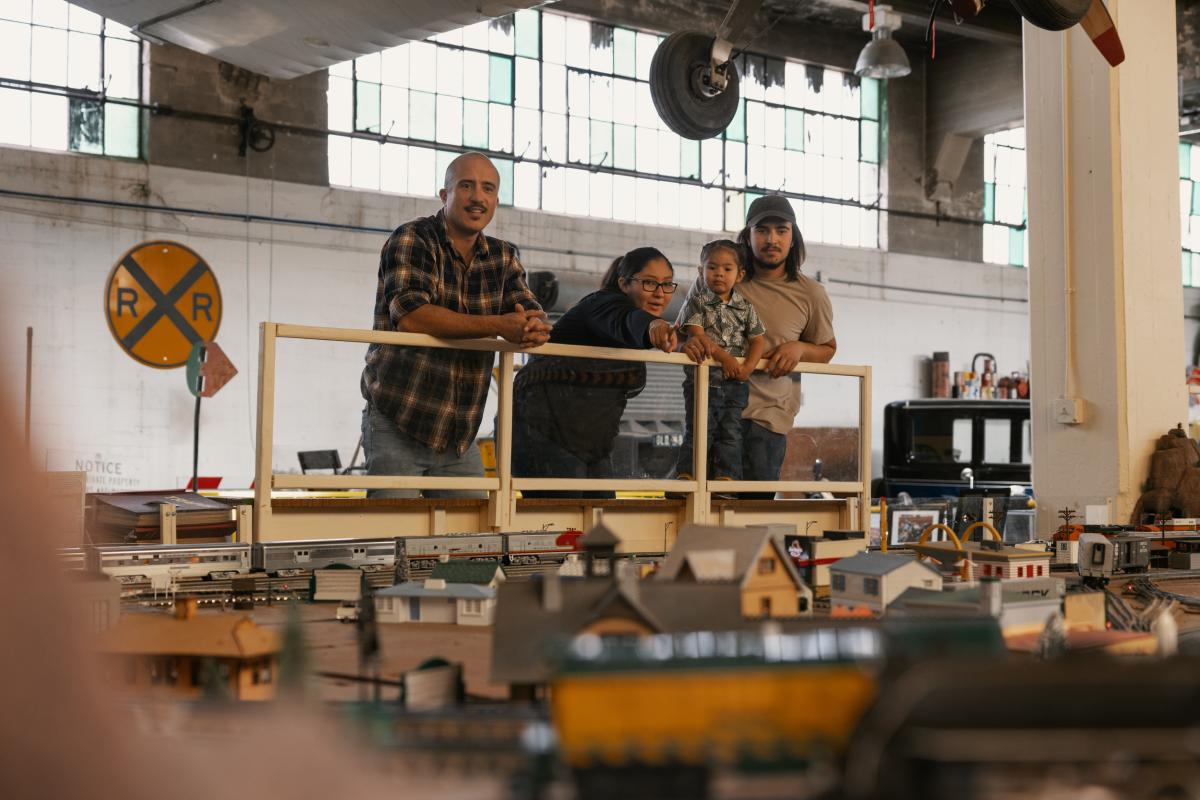 A family looks at an exhibit at the Wheels Museum.
