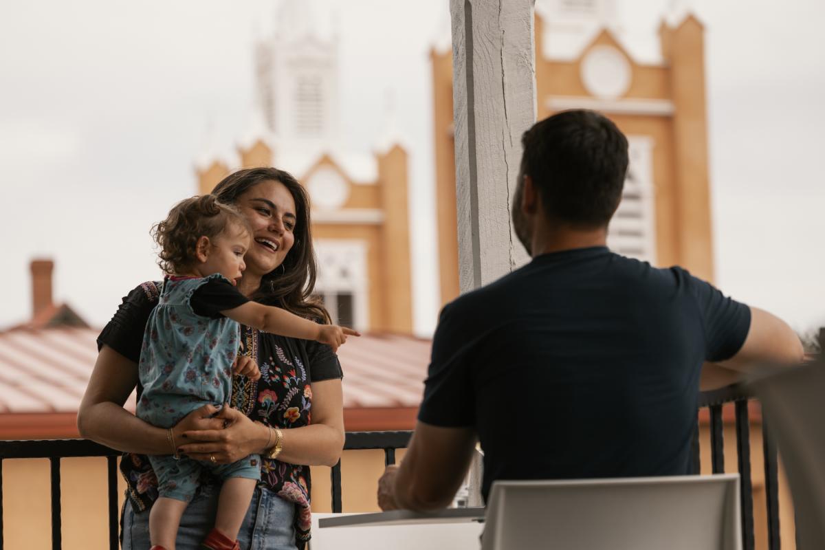 A couple and a baby on a patio in Old Town.