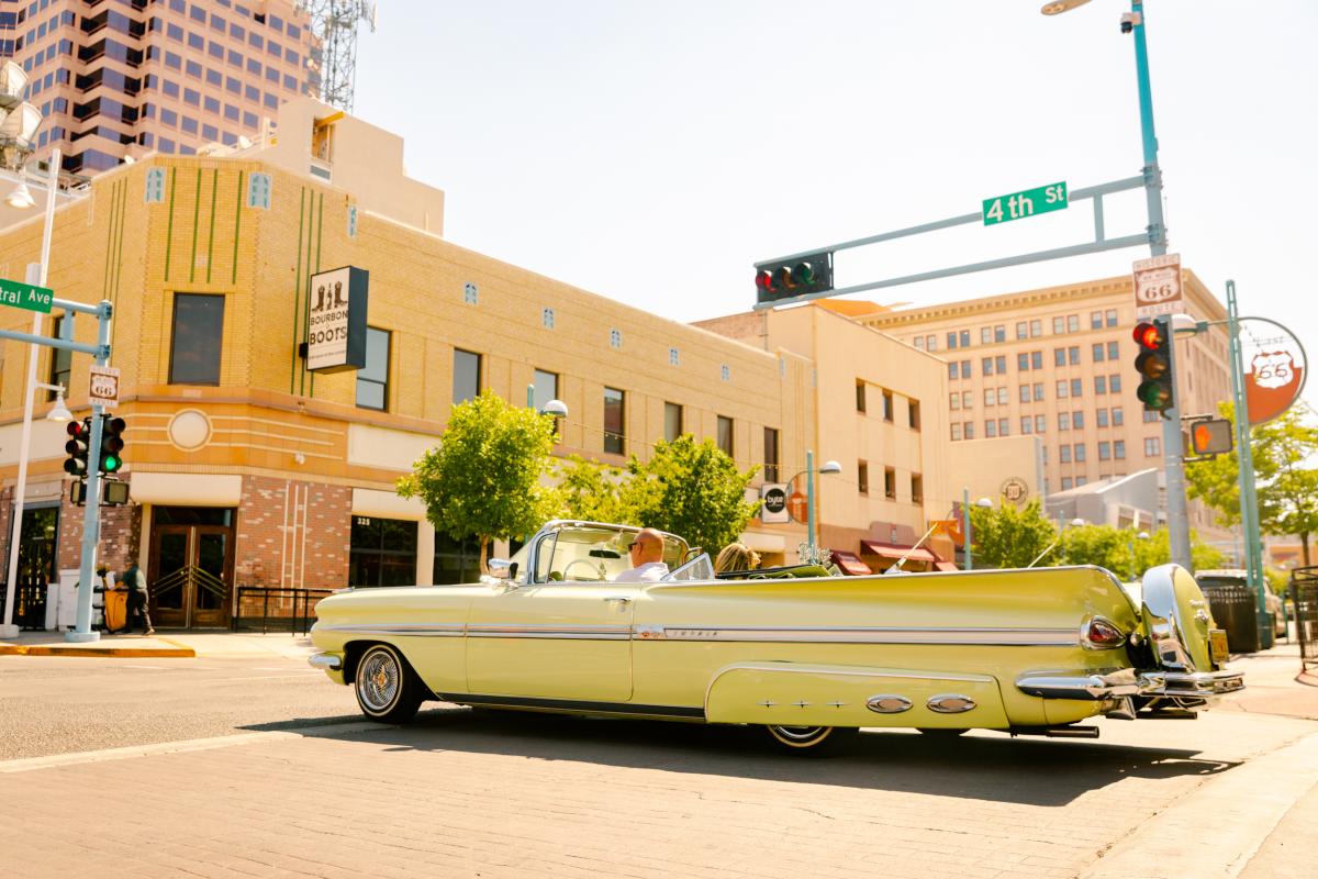 A lowrider cruises through the intersection of Central Ave. and 4th Street in Downtown Albuquerque.