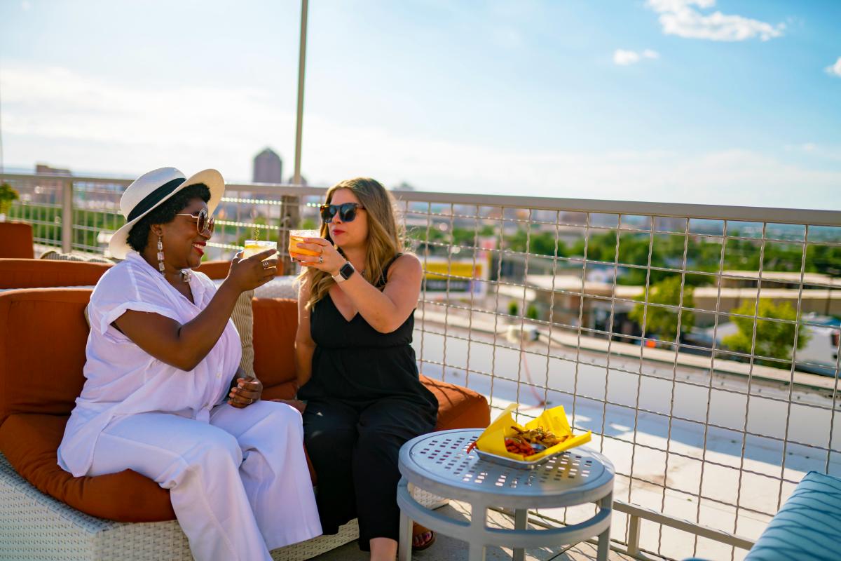 Women at Apothecary Lounge, with cocktails