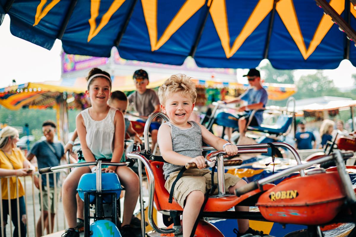 A child rides on a merry-go-round at the Allegany County Fair.