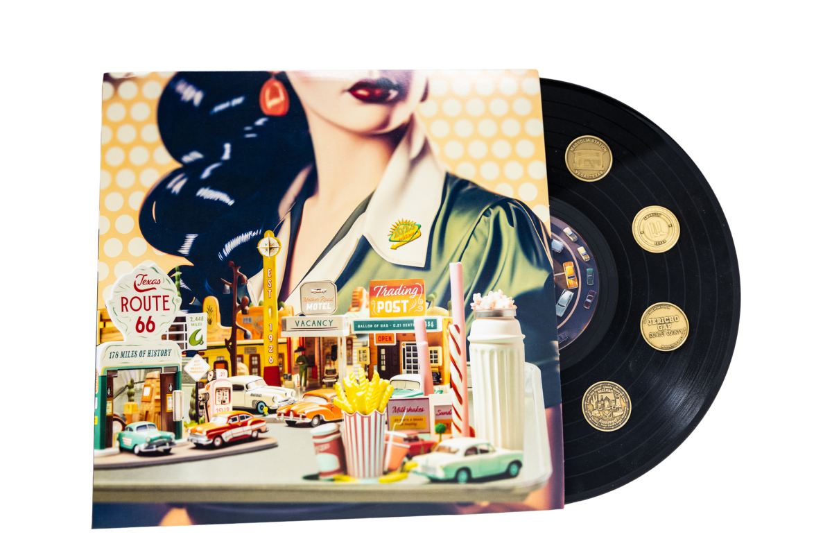 Imagine holding a large, flat circular object, about the size of a dinner plate. This is a vinyl record, which is traditionally used to play music on a turntable. The record is classic black with grooves on its surface, and there are shiny, coin-sized slots on it where small, metallic tokens can be placed.  Now, picture small, coin-shaped objects, each one embossed with intricate designs that you can feel with the tips of your fingers. These coins represent various towns and notable stops along Texas Route 66, a famous highway. Each coin can be collected during travels and fits neatly into the designated slots on the vinyl, creating a tangible memory of the journey.  Behind this record is a vividly colored piece of art. You'll feel the texture of the canvas if you run your hands over it. The artwork features a large illustration of a woman's side profile. She has full, red lips, and you can sense the outline of her wavy hair cascading down. Below this image, there are miniature 3D models of classic cars and iconic American roadside attractions like gas stations, diners, and motels. These are small enough to hold in your hand and are intricately detailed, providing a physical representation of a nostalgic American road trip on the historic Route 66.