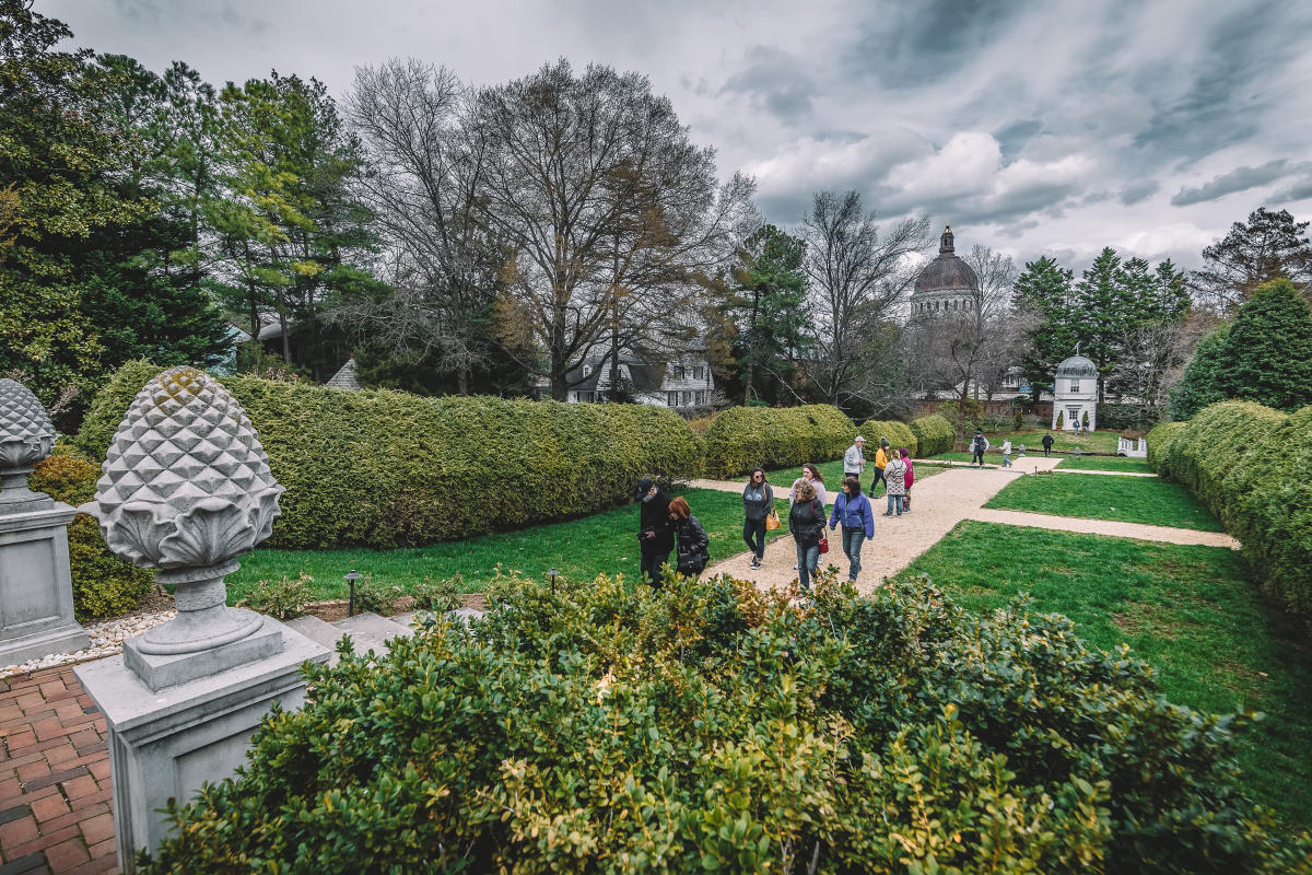 Tour group walking through William Paca Garden for Maryland Day
