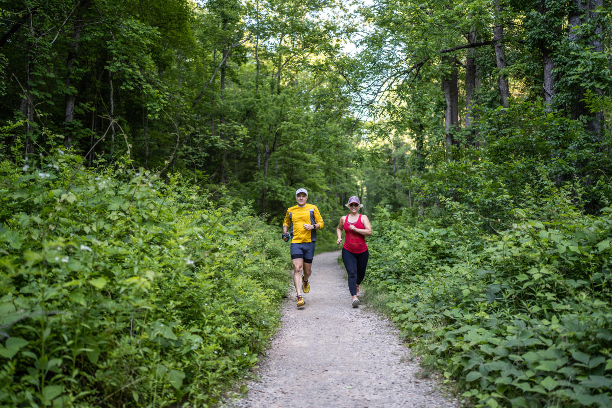 Couple trail running in Bent Creek Experimental Forest