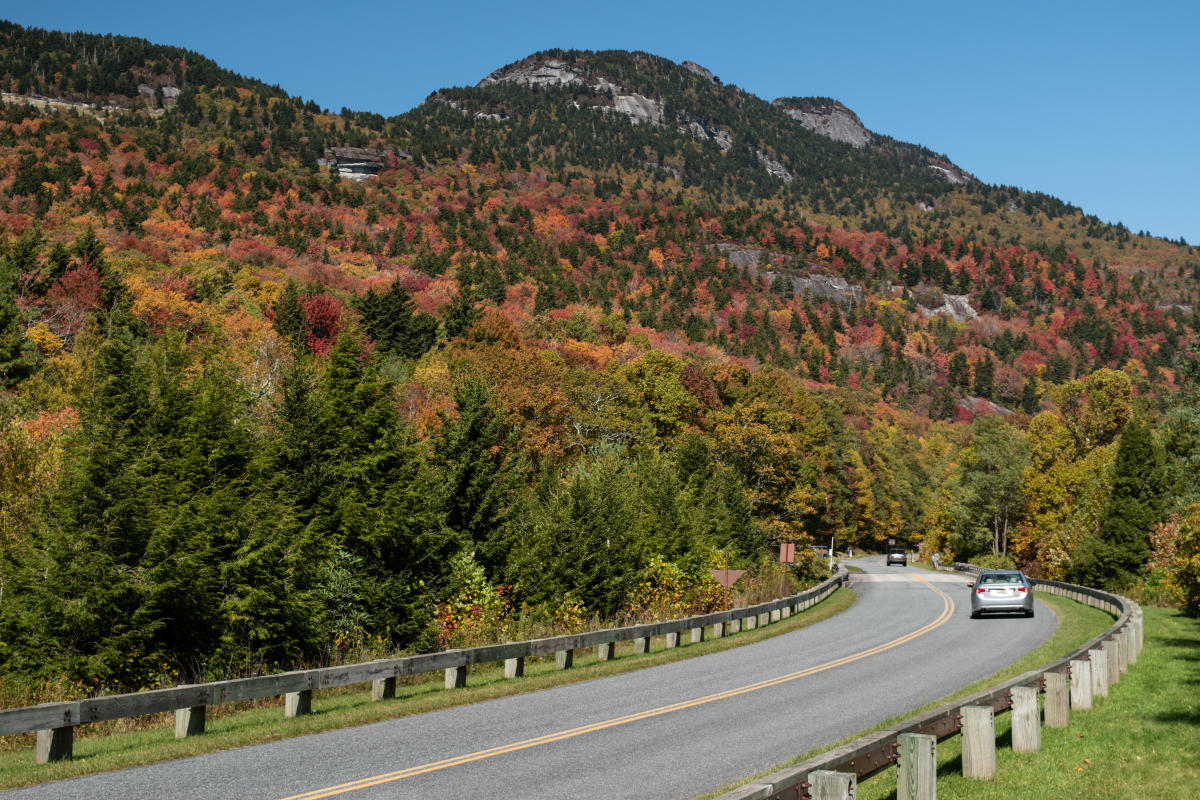 Grandfather Mountain stands out against a blue sky during fall 2020